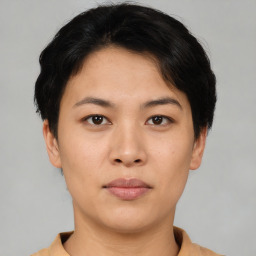 Joyful asian young-adult female with short  black hair and brown eyes