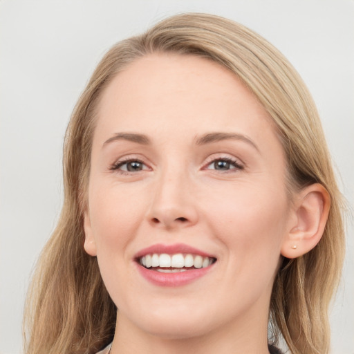 Joyful white young-adult female with medium  brown hair and blue eyes