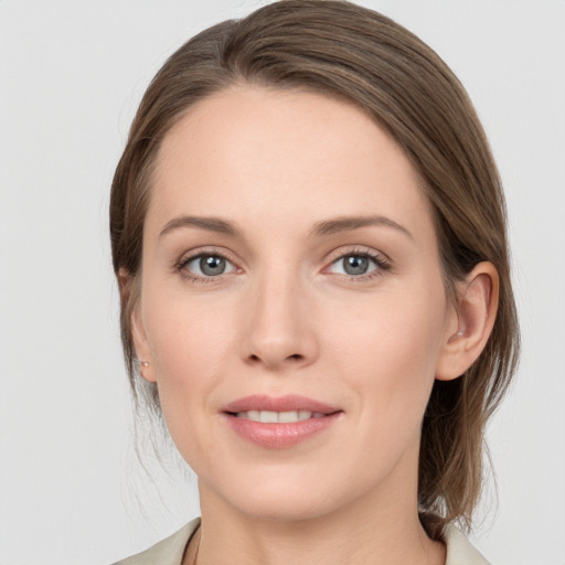 Joyful white young-adult female with medium  brown hair and grey eyes