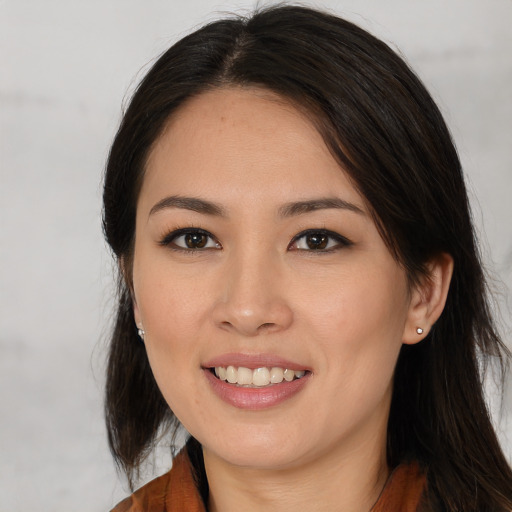 Joyful asian young-adult female with long  brown hair and brown eyes