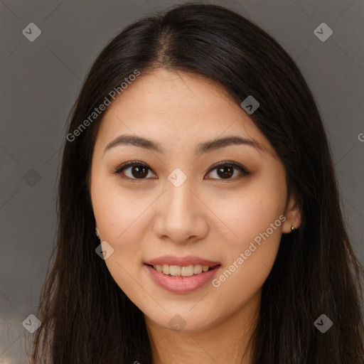 Joyful asian young-adult female with long  brown hair and brown eyes