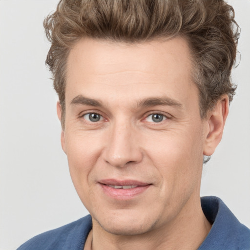 Joyful white adult male with short  brown hair and grey eyes