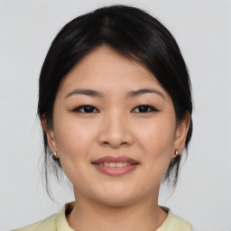 Joyful asian young-adult female with medium  brown hair and brown eyes