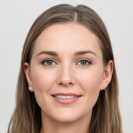 Joyful white young-adult female with long  brown hair and grey eyes