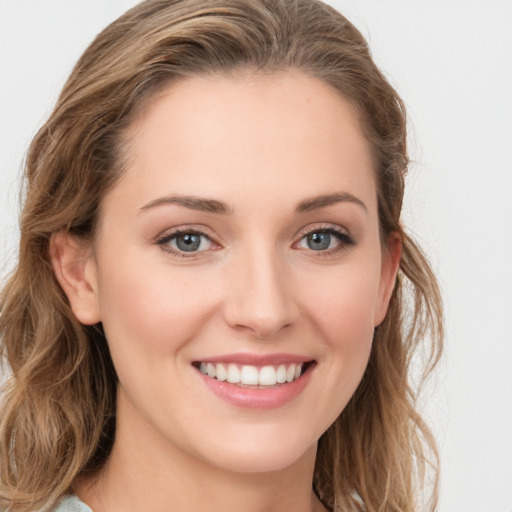 Joyful white young-adult female with long  brown hair and blue eyes