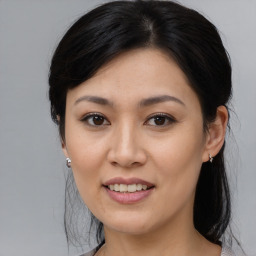 Joyful asian young-adult female with medium  black hair and brown eyes