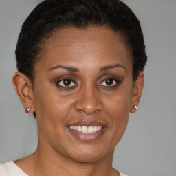 Joyful black young-adult female with short  brown hair and brown eyes
