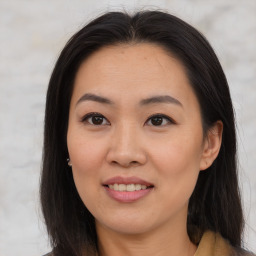 Joyful asian young-adult female with long  brown hair and brown eyes