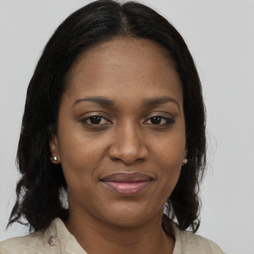 Joyful black young-adult female with medium  brown hair and brown eyes