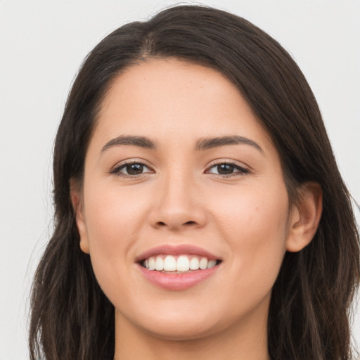 Joyful white young-adult female with long  brown hair and brown eyes