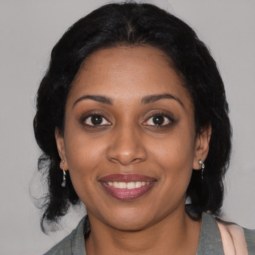 Joyful black young-adult female with medium  black hair and brown eyes