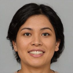 Joyful asian young-adult female with medium  brown hair and brown eyes