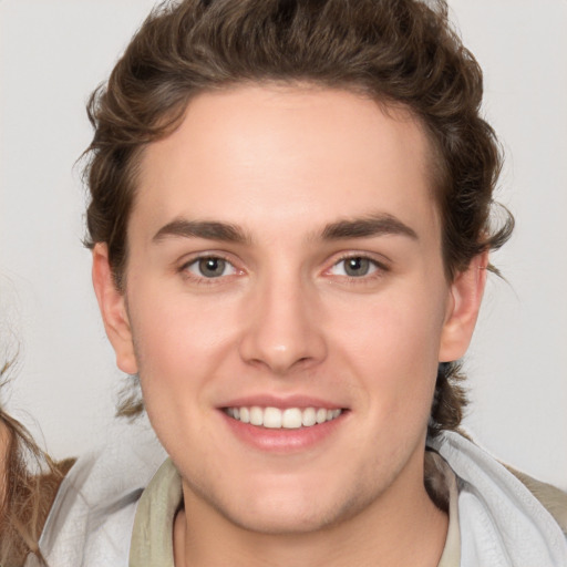 Joyful white young-adult male with medium  brown hair and brown eyes