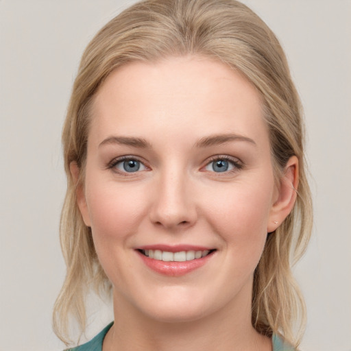 Joyful white young-adult female with medium  brown hair and blue eyes