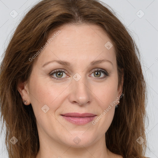 Joyful white adult female with long  brown hair and brown eyes