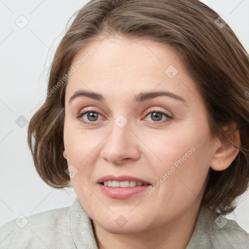 Joyful white young-adult female with medium  brown hair and blue eyes