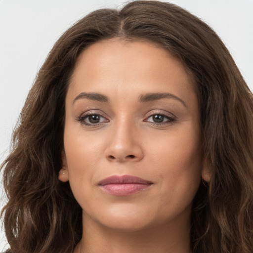 Joyful white young-adult female with long  brown hair and brown eyes