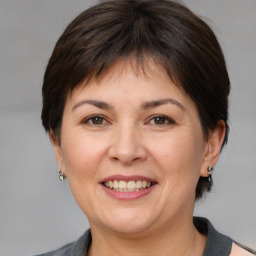 Joyful white adult female with medium  brown hair and brown eyes