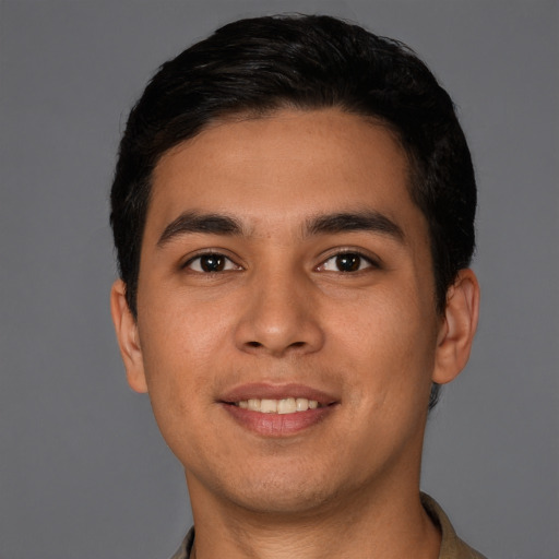 Joyful white young-adult male with short  black hair and brown eyes