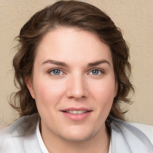 Joyful white young-adult female with medium  brown hair and blue eyes