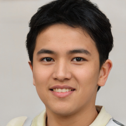 Joyful asian young-adult male with short  brown hair and brown eyes
