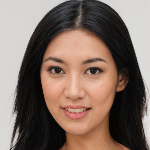 Joyful asian young-adult female with long  black hair and brown eyes