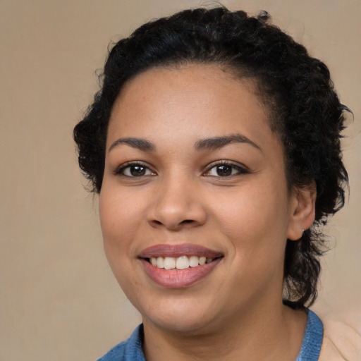 Joyful black young-adult female with medium  brown hair and brown eyes