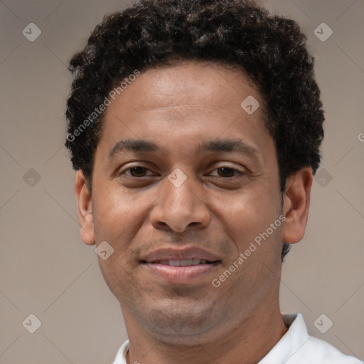 Joyful latino adult male with short  brown hair and brown eyes