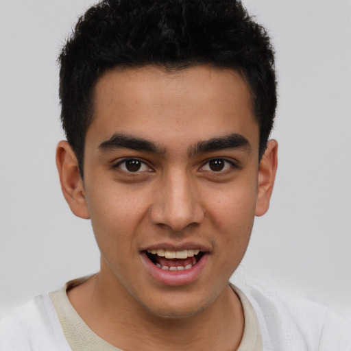 Joyful latino young-adult male with short  brown hair and brown eyes