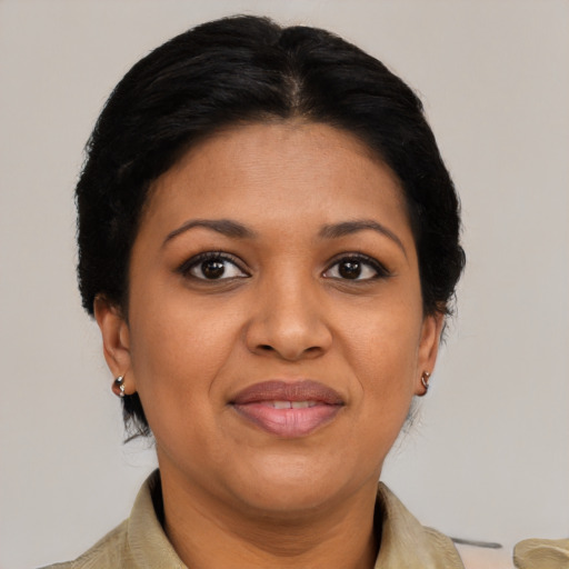 Joyful latino adult female with short  brown hair and brown eyes