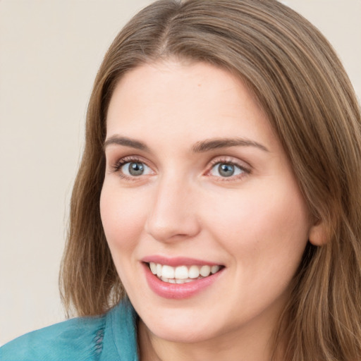 Joyful white young-adult female with long  brown hair and green eyes