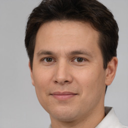 Joyful white adult male with short  brown hair and brown eyes