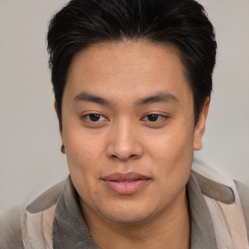 Joyful asian young-adult male with short  brown hair and brown eyes