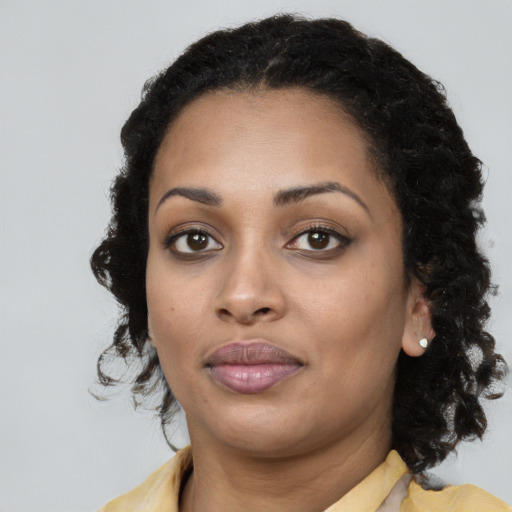 Neutral black young-adult female with medium  brown hair and brown eyes