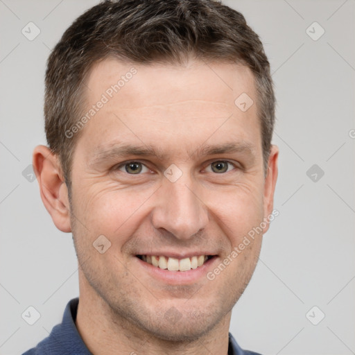 Joyful white adult male with short  brown hair and grey eyes