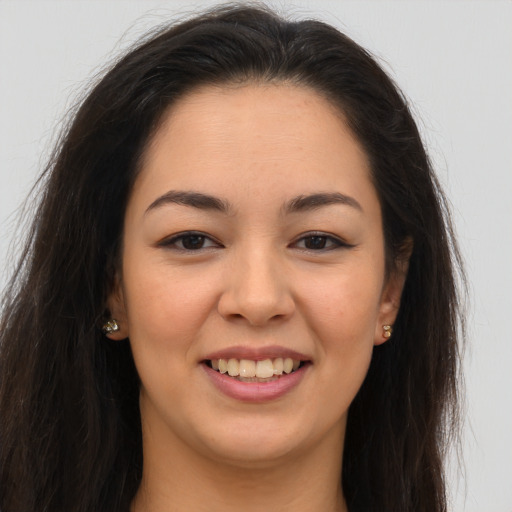 Joyful white young-adult female with long  brown hair and brown eyes