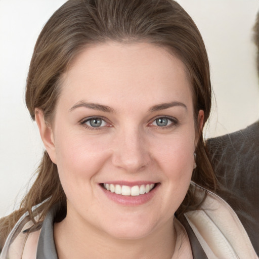 Joyful white young-adult female with medium  brown hair and grey eyes