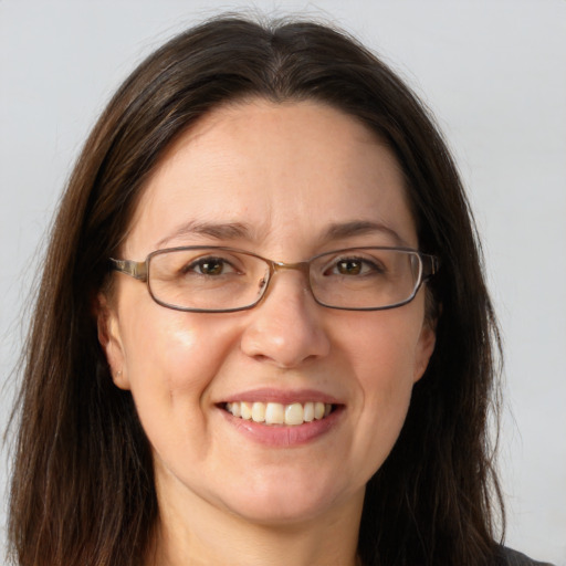 Joyful white adult female with long  brown hair and grey eyes