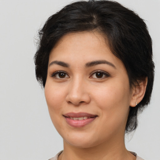 Joyful latino young-adult female with medium  brown hair and brown eyes