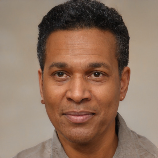 Joyful latino adult male with short  black hair and brown eyes