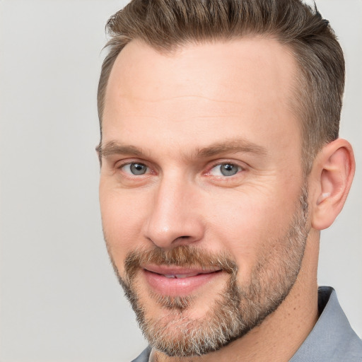 Joyful white adult male with short  brown hair and brown eyes