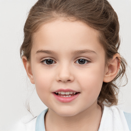 Joyful white child female with medium  brown hair and brown eyes