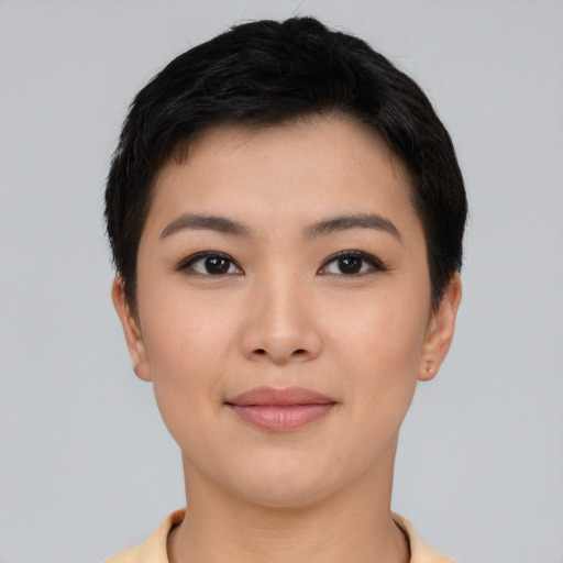 Joyful asian young-adult female with short  black hair and brown eyes