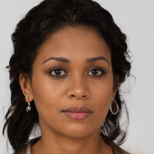 Neutral black young-adult female with long  brown hair and brown eyes