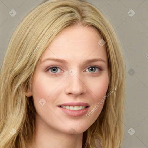 Joyful white young-adult female with long  brown hair and blue eyes