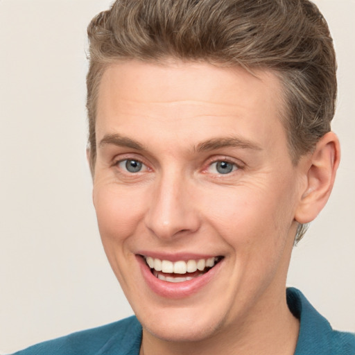 Joyful white young-adult male with short  brown hair and blue eyes