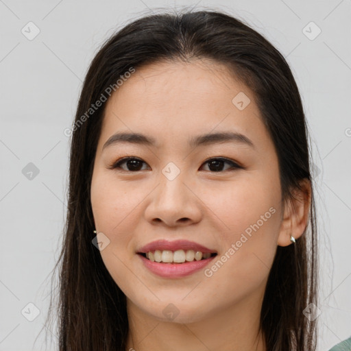 Joyful asian young-adult female with long  brown hair and brown eyes