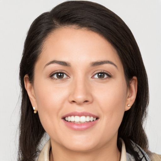 Joyful white young-adult female with long  brown hair and brown eyes