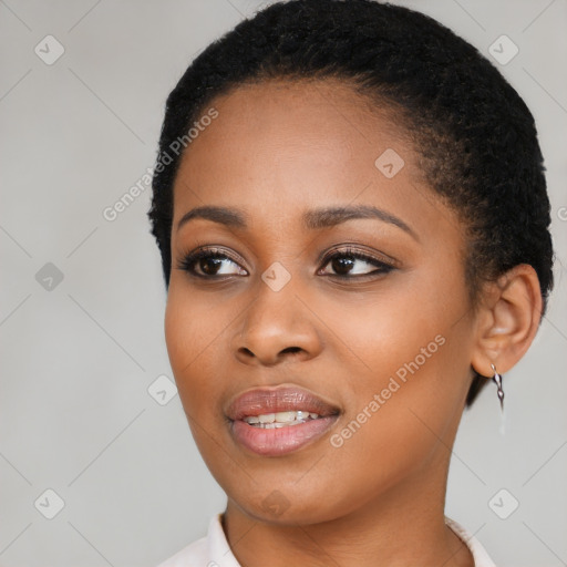 Joyful black young-adult female with short  black hair and brown eyes