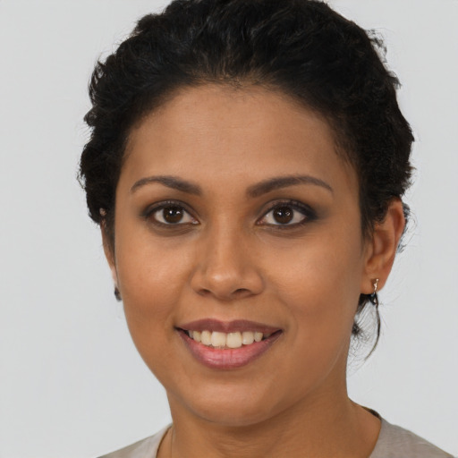Joyful latino young-adult female with short  brown hair and brown eyes